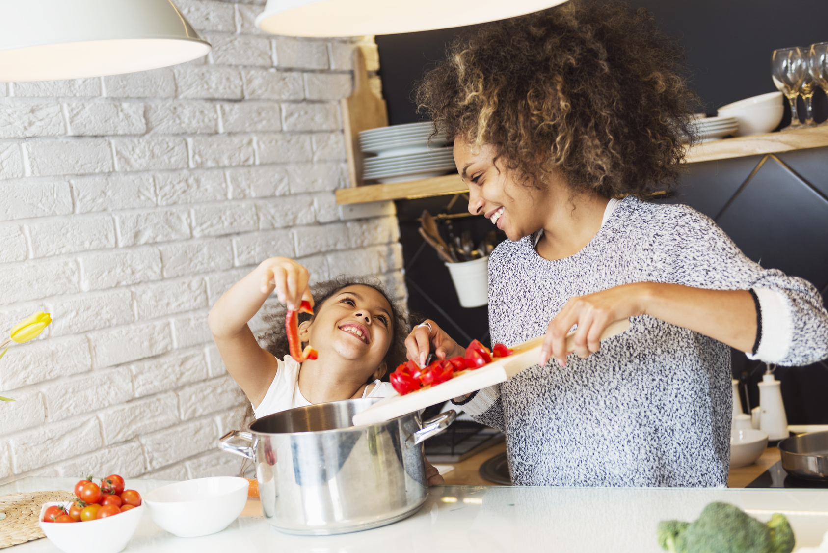 Mother and daugher connecting in a meaningful way while cooking in the kitchen