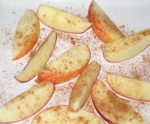 apple wedges sprinkled with cinnamon