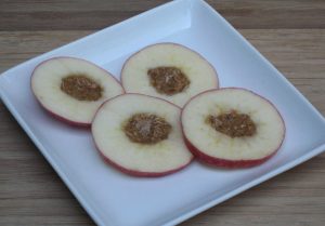 cored apples with almond butter inside